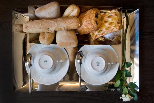 a tray filled with different types of bread and pastries at Casa Montani in Rome