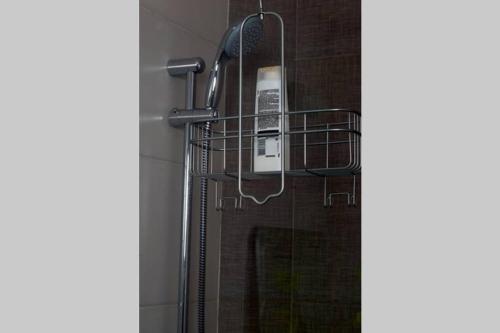 a bathroom with a shower with a phone on the wall at Lujoso y acogedor condominio ejecutivo/familiar in San Pedro Sula