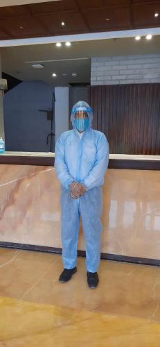 a man in a blue suit standing in a bowling alley at YASH INTERNATIONAL in Kozhikode