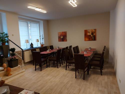 a dining room with tables and chairs and a window at Mabri Apartments Plauen in Plauen