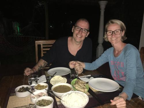 a man and woman sitting at a table with food at Marari Dreamz Homestay in Mararikulam
