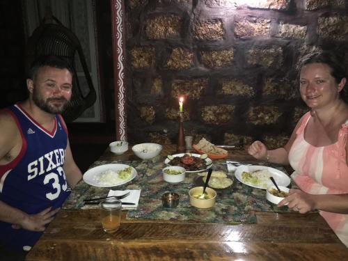 a man and a woman standing in front of a table with food at Marari Dreamz Homestay in Mararikulam
