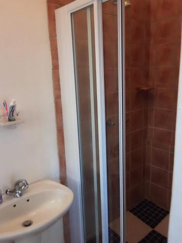 a bathroom with a shower and a sink at Yonz Self Catering Units in Port Alfred