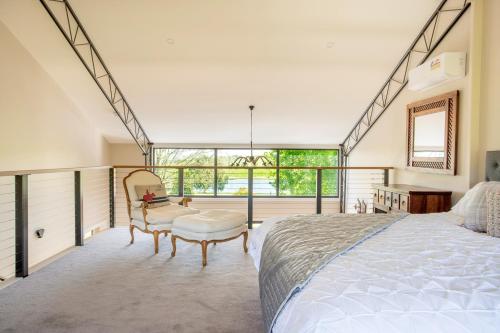 a bedroom with a large bed and a large window at Altitude221 in Mansfield