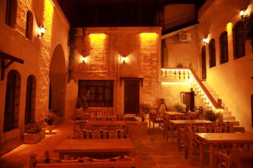 a room with tables and chairs in a building at Aslan Guest House in Sanlıurfa