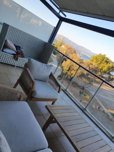 a living room with chairs and a large window at Anny's studio in Chalkida