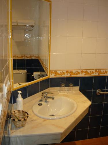 a bathroom with a sink and a mirror at Hotel Rural Suquin in Navia
