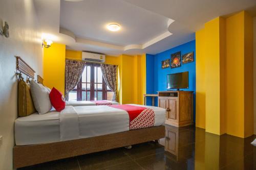Ένα ή περισσότερα κρεβάτια σε δωμάτιο στο Yellow Tique Hotel
