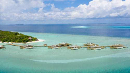 an aerial view of a resort in the ocean at Soneva Fushi in Baa Atoll