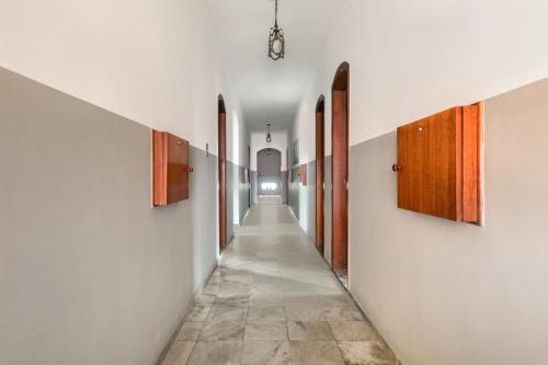 a hallway with white walls and a long hallway at Hotel Park Leste, São Paulo in Sao Paulo