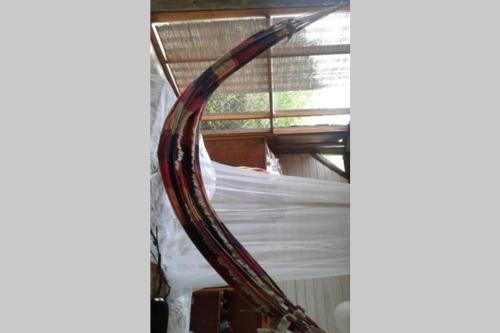 a large wooden mirror hanging from a window at Vila Renata in Playa Hermosa