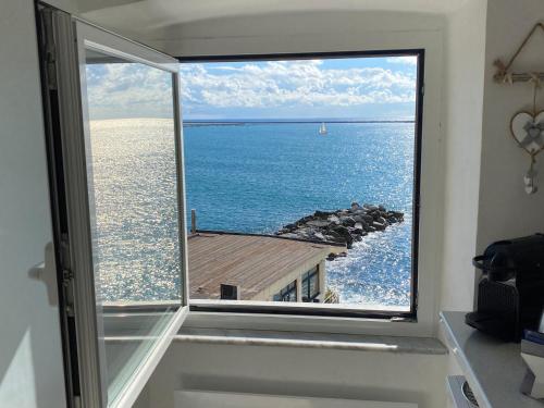 a window in a room with a view of the ocean at La Casetta di Dory sul Mare in Genova