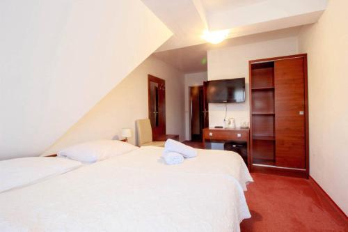 a hotel room with two beds and a bathroom at Willa Stożek, 50 m od term i wyciągów narciarskich in Białka Tatrzanska