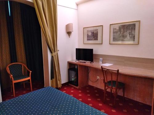 a hotel room with a desk with a computer on it at Polo Hotel in Usmate Velate