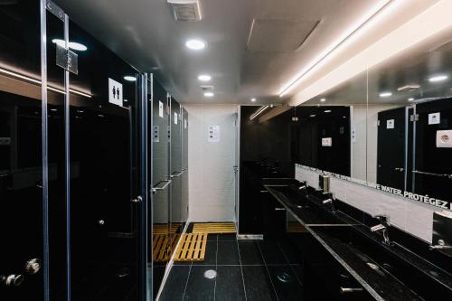 a bathroom with a row of stalls in a gym at Lisbon South Hostel in Almada