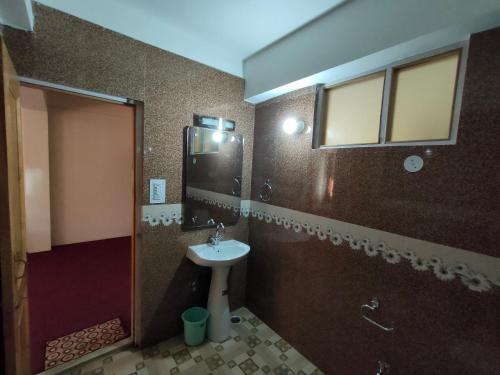 a bathroom with a sink and a shower at The Destination Manali in Manāli