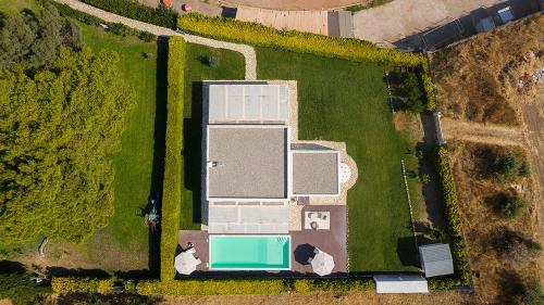 an overhead view of a house with a swimming pool at Villa Perla Blanca in Platánion