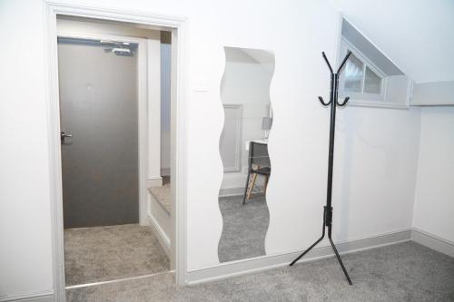a room with a door and a tripod next to a doorway at Castle View in Dudley