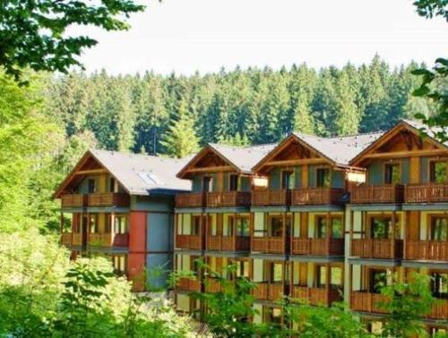 a large apartment building with trees in the background at Fatrapark 2 Apartments House in Ružomberok