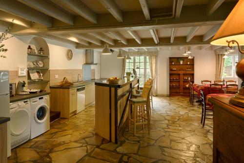 a kitchen with a washer and dryer in a room at Maison de vacance La Cavalière in Accous