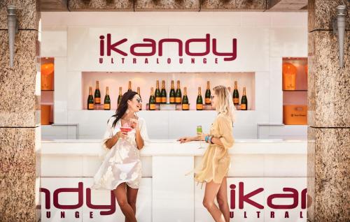 two women standing at a bar with wine bottles at Shangri-La Dubai in Dubai