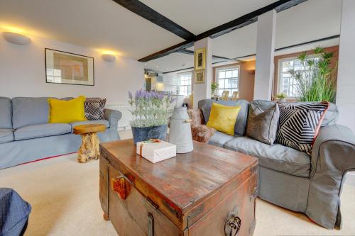 a living room with couches and a coffee table at The Butter Market Overlook - An Exquisite Getaway! in Canterbury