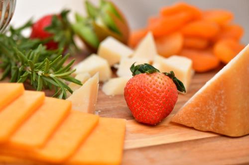 a block of cheese and a strawberry on a cutting board at Holiday Inn Jeddah Gateway by IHG in Jeddah