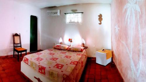 Ένα ή περισσότερα κρεβάτια σε δωμάτιο στο Pousada Chez Roni
