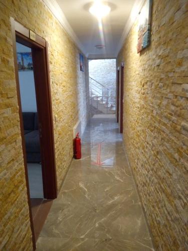 a hallway with a brick wall and a red fire hydrant at Asmir Suites Hotel in Nevsehir