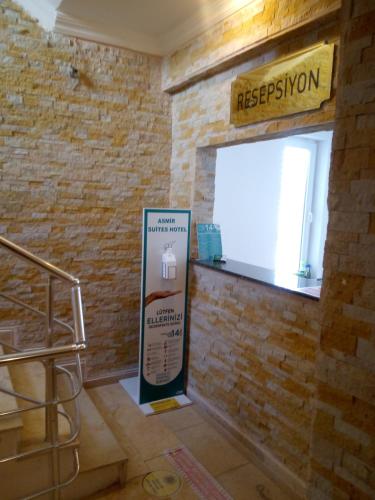 a sign in a room with a brick wall at Asmir Suites Hotel in Nevsehir