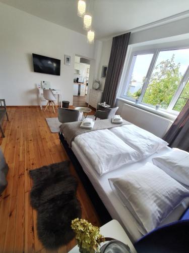 a large bed in a room with a large window at Apartamenty pod Wieżą in Zgorzelec