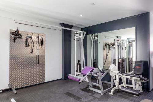 a gym with treadmills and exercise equipment in a room at Gray Door Apartments - Adults only in Palm-Eagle Beach