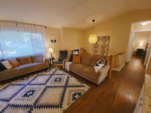 a living room with two couches and a rug at Indoor Pool, Firepit, Self Check-in, BBQ, FREE Amenities, KING Bed, Full Kitchen in Lake Ariel