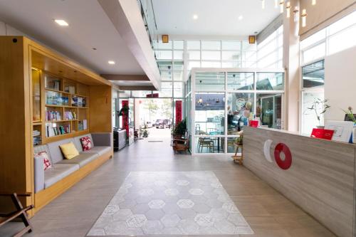 a lobby of a store with a counter and chairs at Golden Beach Boutique Resort in Prachuap Khiri Khan