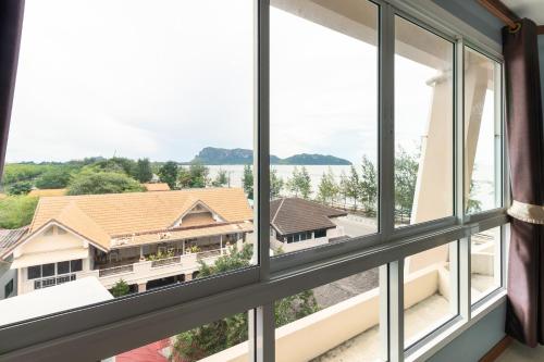 a window with a view of a building at Golden Beach Boutique Resort in Prachuap Khiri Khan
