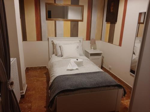 Un pequeño dormitorio con una cama con una toalla. en Residenza Rialto, en Bolonia