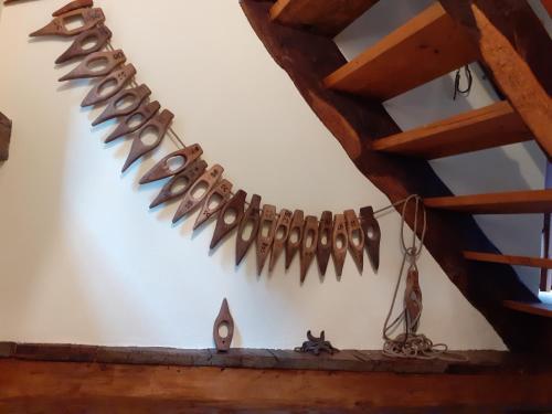 a row of fish hooks hanging from a ceiling at tana del paradiso due in Baceno