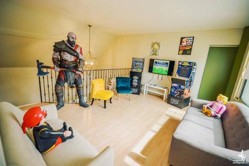 a living room with a man in a superhero costume at Maison PISCINE INTERIEURE et GARAGE in Troyes