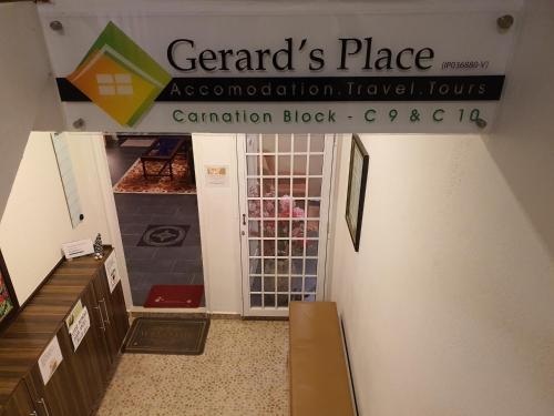 a sign for a store with a door open at Gerard's Place Roomstay in Cameron Highlands