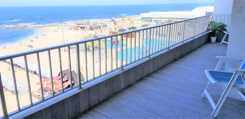 a balcony with a view of the beach and the ocean at Avenida dos Banhos Apartment in Póvoa de Varzim