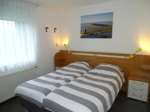 Postel nebo postele na pokoji v ubytování Vakantiehuis Noord-Beveland kort bij de zee
