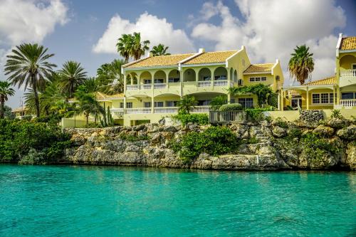 a house on the shore of a body of water at Curacao Luxury Holiday Rentals in Willemstad