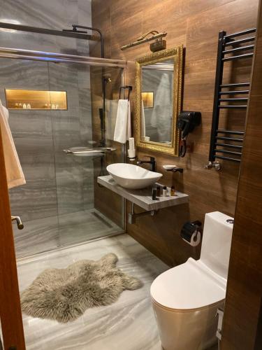 a bathroom with a sink and a shower and a toilet at Wine Hills in Tbilisi City
