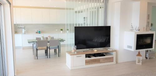 a living room with a large flat screen tv at Avenida dos Banhos Apartment in Póvoa de Varzim