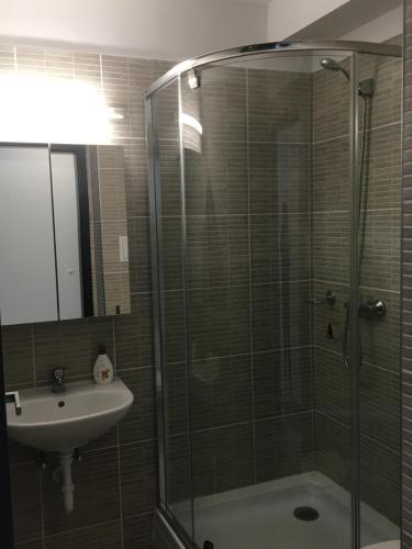 a bathroom with a glass shower and a sink at Apartmanhotel Baraton*** in Balatonfüred