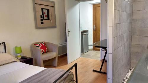 a bedroom with a bed and a desk in a room at Hôtel - Gîte de Pressins in Pressins