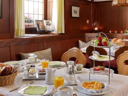 a table with plates of food and fruit on it at Landgasthof Ochsen in Seelbach