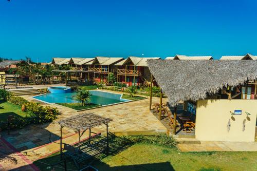 an aerial view of a resort with a swimming pool at ChaleVille coqueiro - Chalé 2101 in Luis Correia