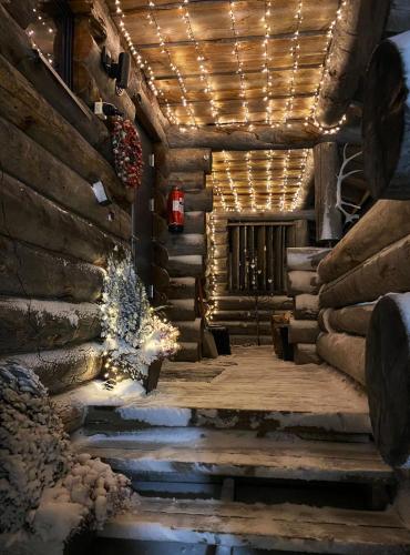 a hallway with christmas lights and a fireplace at Ylämaja - with a stunning view in Ruka