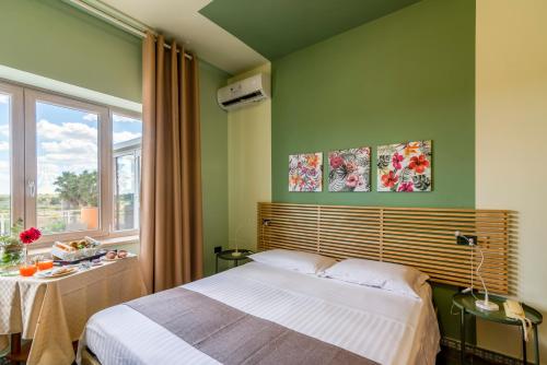 Un pat sau paturi într-o cameră la Hotel Villa Maria